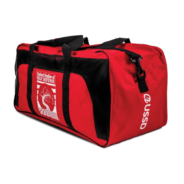 Red and black sports duffel bag with self-defense branding.