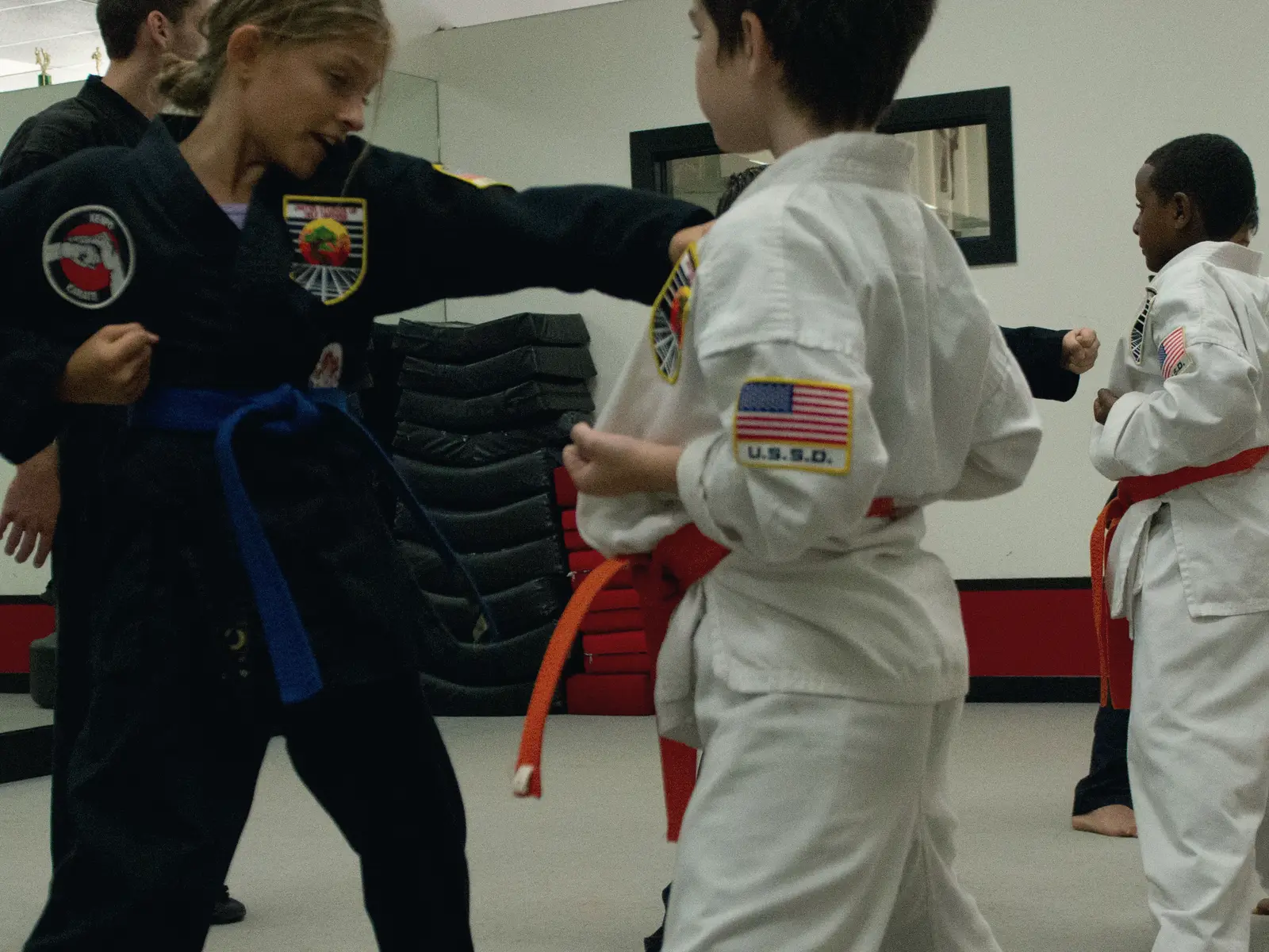Students sparring with an instructor on the training floor at USSD Santa Barbara.